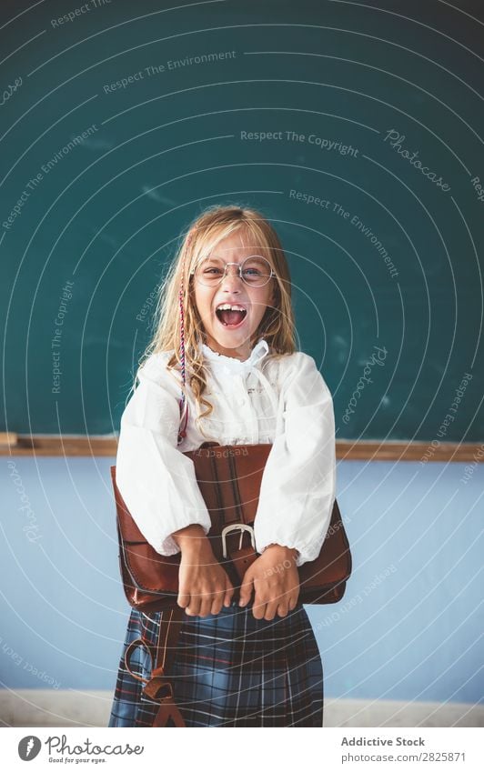 Pupil at chalkboard with briefcase in hand Girl Classroom Blackboard Stand Cheerful Happy Book Chalk Cute Education School Grade (school level) Student