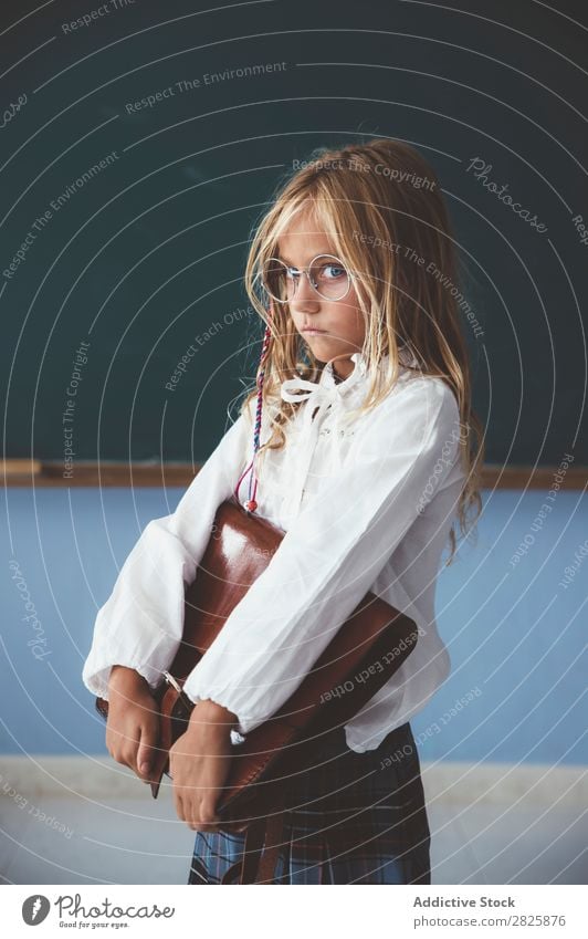 Pupil at chalkboard with briefcase in hand Girl Classroom Blackboard Stand Cheerful Happy Book Chalk Cute Education School Grade (school level) Student