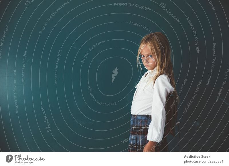 Pupil posing in classroom Girl Classroom Blackboard Stand Cheerful Book Chalk Cute Education School Grade (school level) Student Youth (Young adults) Study