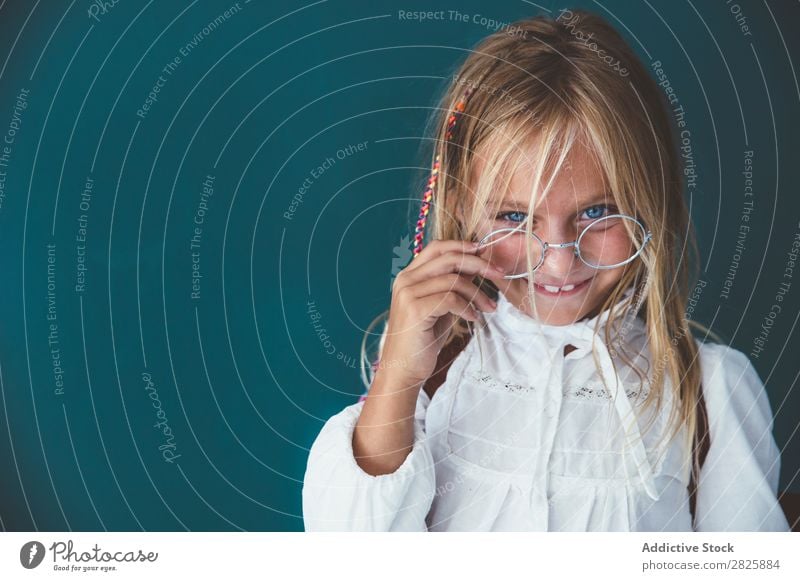 Pupil posing in classroom Girl Classroom Blackboard Stand Cheerful Book Chalk Cute Education School Grade (school level) Student Youth (Young adults) Study