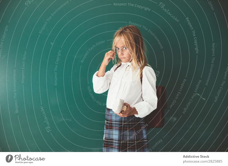 Pupil posing in classroom Girl Classroom Blackboard Stand Cheerful Book Chalk Cute Education School Grade (school level) Student Youth (Young adults) Study