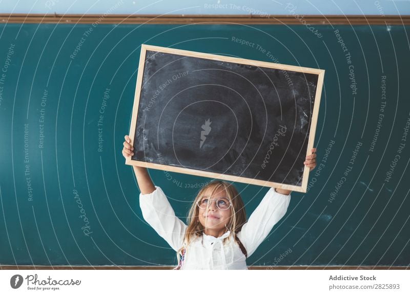 Happy girl standing with chalkboard Girl Classroom Blackboard Stand Hold Scream over head Cheerful Cute Education School Grade (school level) Student