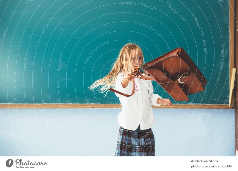 Girl throwing backpack in classroom Classroom Blackboard Joy Backpack Vacation & Travel Happy Cheerful Stand Cute Education School Grade (school level) Student