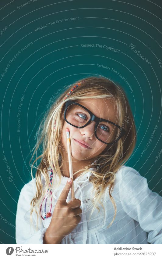 Cute schoolgirl with pencil Girl Classroom Blackboard Person wearing glasses Pencil Smiling Cheerful Stand Education School Grade (school level) Student