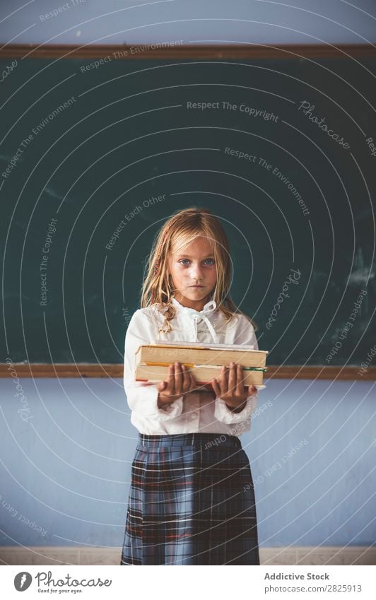 Pupil at chalkboard with books in hand Girl Classroom Blackboard Stand Cheerful Happy Book Chalk Cute Education School Grade (school level) Student