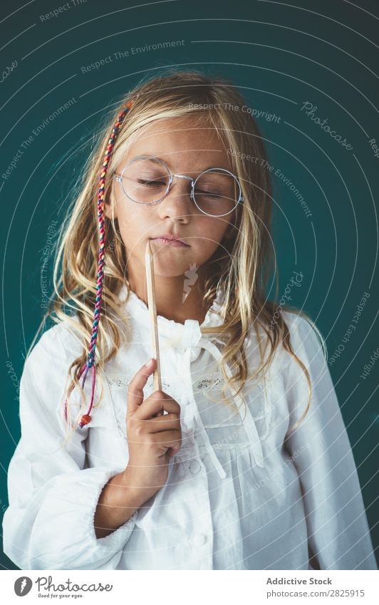 Cute schoolgirl with pencil Girl Classroom Blackboard Person wearing glasses Pencil Cheerful Stand Education School Grade (school level) Student