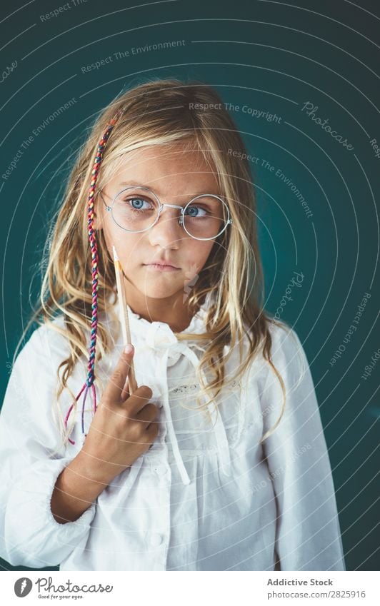 Cute schoolgirl with pencil Girl Classroom Blackboard Person wearing glasses Pencil Cheerful Stand Education School Grade (school level) Student