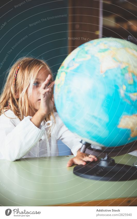 Pupil girl pointing at globe Girl Classroom Sit Globe Geography Indicate Cute Education School Grade (school level) Student Youth (Young adults) Study Child