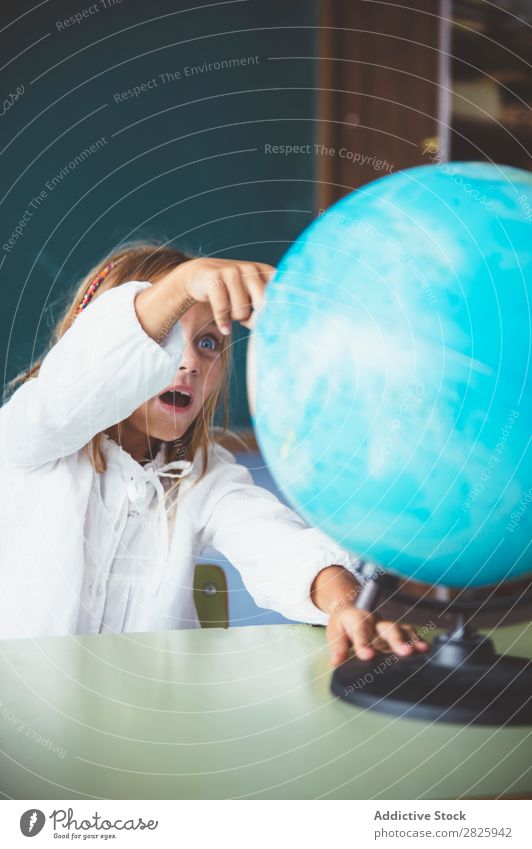 Pupil girl pointing at globe Girl Classroom Sit Globe Geography Indicate Cute Education School Grade (school level) Student Youth (Young adults) Study Child