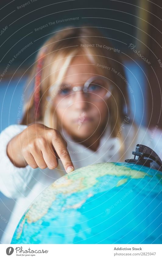 Pupil girl pointing at globe Girl Classroom Sit Globe Geography Indicate Cute Education School Grade (school level) Student Youth (Young adults) Study Child