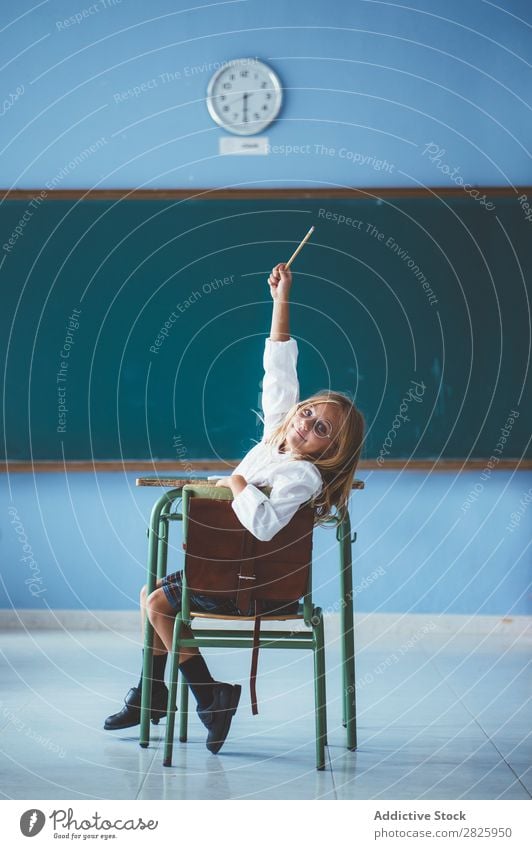 Smiling girl with pencil in class Girl Classroom Blackboard Sit Looking into the camera Pencil Happy Cheerful hand up Cute Education School Grade (school level)