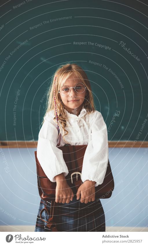 Pupil at chalkboard with briefcase in hand Girl Classroom Blackboard Stand Cheerful Happy Book Chalk Cute Education School Grade (school level) Student