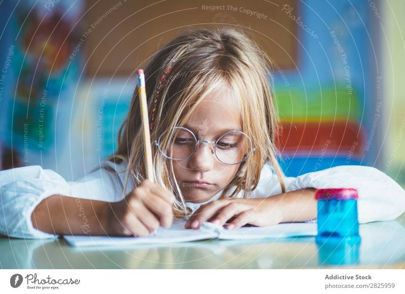 Thoughtful girl writing in class Girl Classroom Sit Desk Writing Pencil Drawing Think Considerate bored Cute Education School Grade (school level) Student