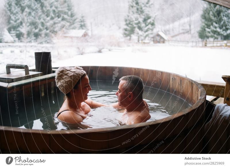 Sensual couple in plunge tub Couple Swimming Nature Winter Water Steam Woman Man Healthy Beautiful Vacation & Travel Romania Float in the water Snow Ice Natural