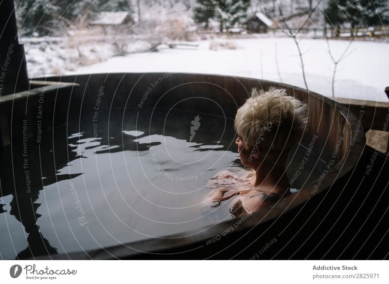 Blonde woman swimming in outside plunge tub Woman Swimming Nature Winter Water Healthy Beautiful Vacation & Travel Romania Float in the water Snow Ice Natural