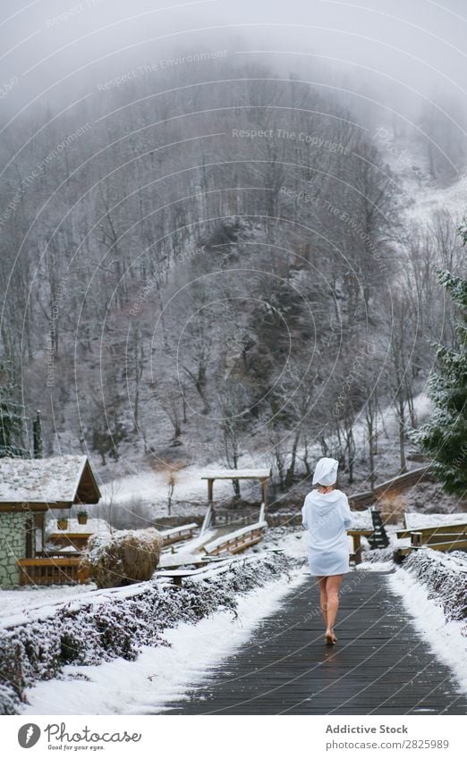 Woman in bathrobe walking to forest Nature Winter Walking Forest boardwalk Corridor Healthy Beautiful Vacation & Travel Romania Snow Bathrobe Ice Natural