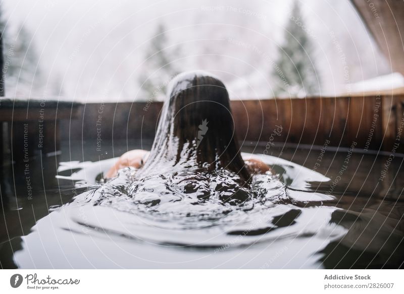 Woman swimming in outside tub Swimming Nature Winter plunge tub Water Healthy Beautiful Vacation & Travel Romania Float in the water Snow Ice Natural