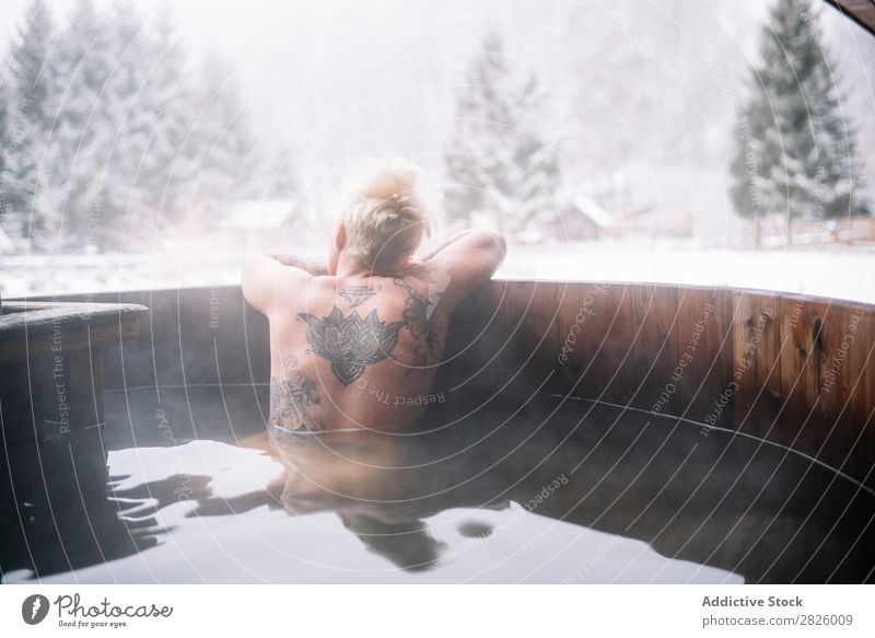 Tattooed blonde woman swimming in plunge tub Woman Swimming Nature Winter topless Water Healthy Beautiful Vacation & Travel Romania Float in the water Blonde