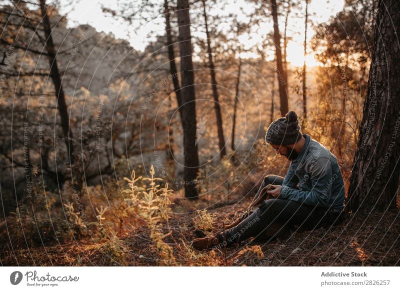 Man in forest looking into backpack Looking Backpack Tourist Forest Portrait photograph Autumn Tourism Vacation & Travel Adventure Youth (Young adults) Trip