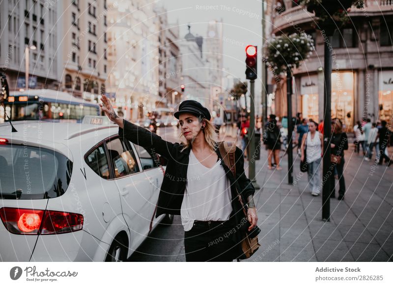 Woman taking taxi in city Taxi Take Street City Youth (Young adults) Lifestyle Vacation & Travel Car Girl Human being Transport Tourist Beautiful Town Tourism