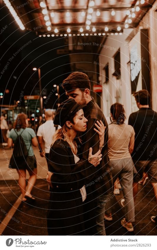 Couple embracing on evening street Evening Street Crowded Love romantic Romance Beautiful Lifestyle Man Woman Together City Lovers Light Illuminate 2