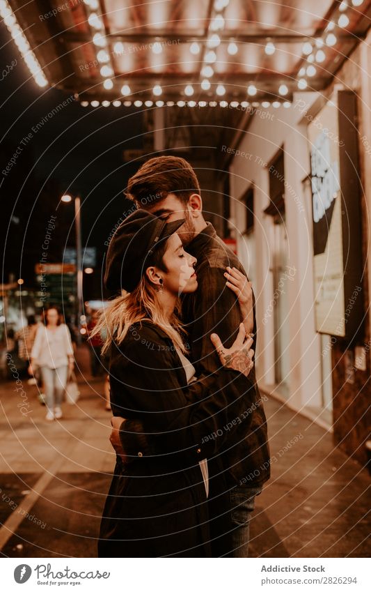 Couple embracing on evening street Evening Street Crowded Love romantic Romance Beautiful Lifestyle Man Woman Together City Lovers Light Illuminate 2