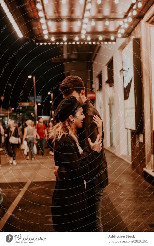 Couple embracing on evening street Evening Street Crowded Love romantic Romance Beautiful Lifestyle Man Woman Together City Lovers Light Illuminate 2