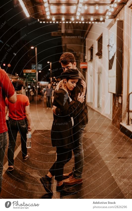 Couple embracing on evening street Evening Street Crowded Love romantic Romance Beautiful Lifestyle Man Woman Together City Lovers Light Illuminate 2