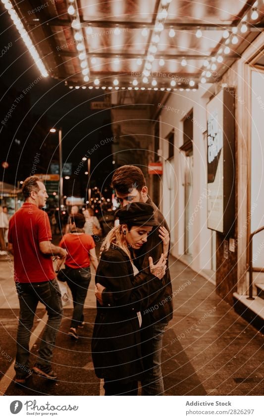 Couple embracing on evening street Evening Street Crowded Love romantic Romance Beautiful Lifestyle Man Woman Together City Lovers Light Illuminate 2