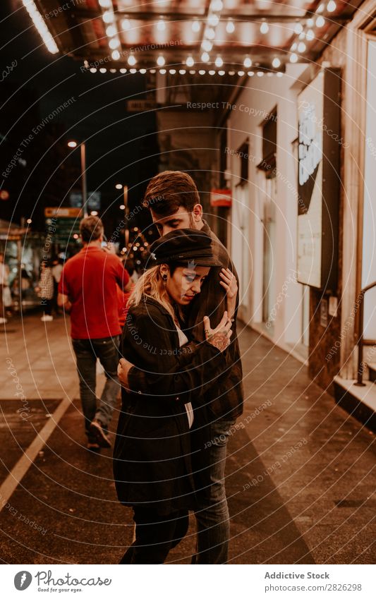 Couple embracing on evening street Evening Street Crowded Love romantic Romance Beautiful Lifestyle Man Woman Together City Lovers Light Illuminate 2