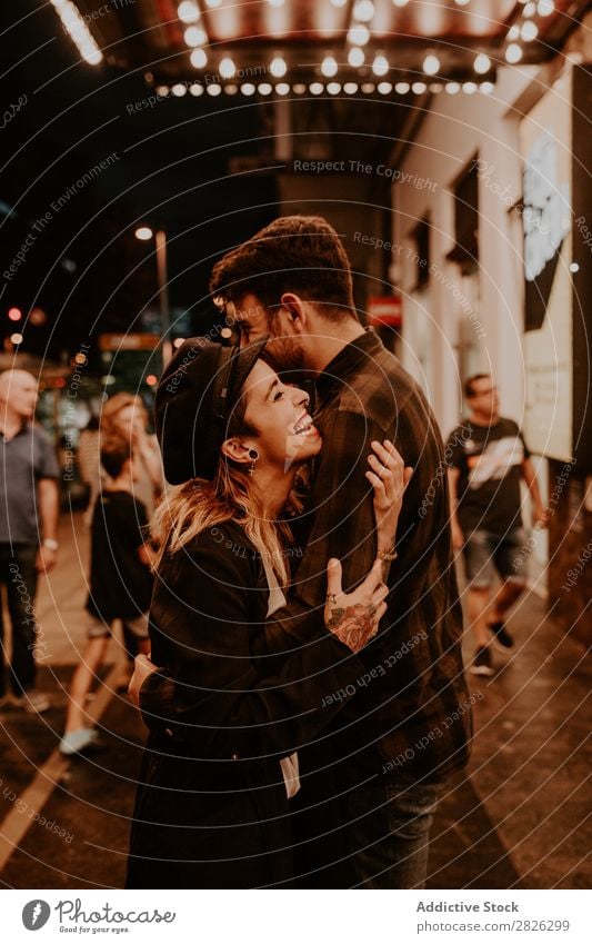 Couple embracing on evening street Evening Street Crowded Love romantic Romance Beautiful Lifestyle Man Woman Together City Lovers Light Illuminate 2