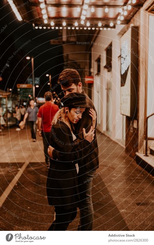 Couple embracing on evening street Evening Street Crowded Love romantic Romance Beautiful Lifestyle Man Woman Together City Lovers Light Illuminate 2