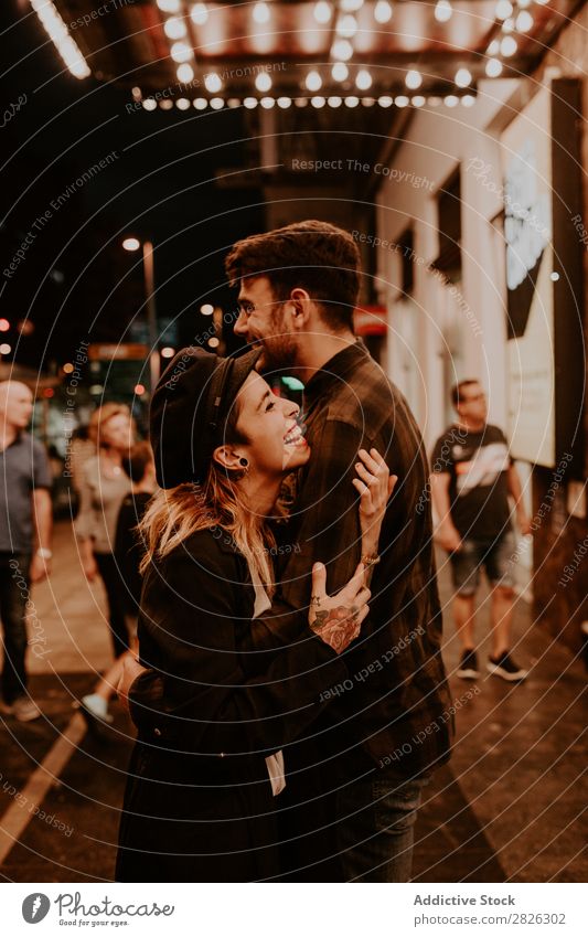 Couple embracing on evening street Evening Street Crowded Love romantic Romance Beautiful Lifestyle Man Woman Together City Lovers Light Illuminate 2