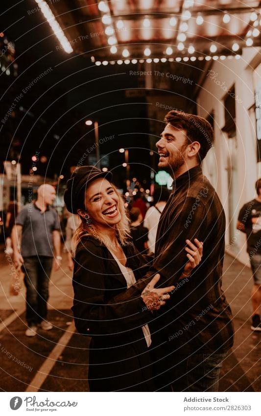 Couple embracing on evening street Evening Street Crowded Love romantic Romance Beautiful Lifestyle Man Woman Together City Lovers Light Illuminate 2