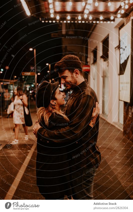 Couple embracing on evening street Evening Street Crowded Love romantic Romance Beautiful Lifestyle Man Woman Together City Lovers Light Illuminate 2