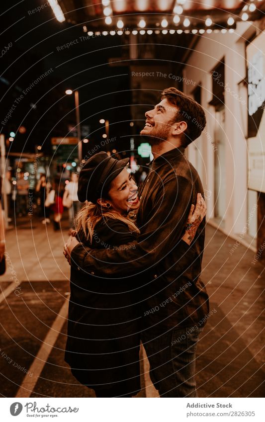 Couple embracing on evening street Evening Street Crowded Love romantic Romance Beautiful Lifestyle Man Woman Together City Lovers Light Illuminate 2