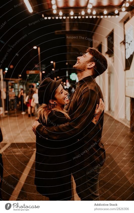 Couple embracing on evening street Evening Street Crowded Love romantic Romance Beautiful Lifestyle Man Woman Together City Lovers Light Illuminate 2