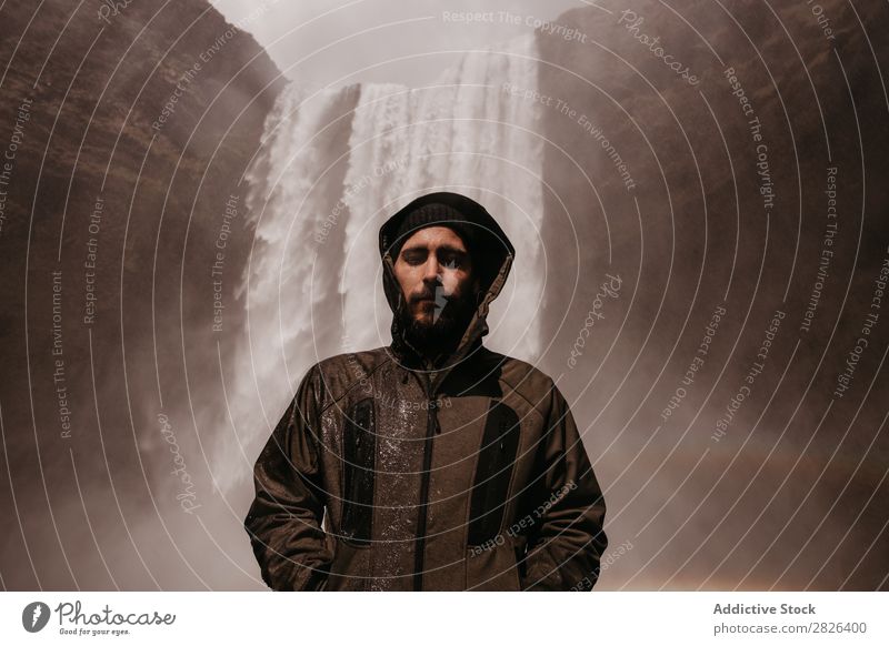 Young man in coat on waterfall Man Waterfall Rainbow Iceland Stream Fog traveler Tourism Mountain Natural Vacation & Travel Landscape Environment Powerful Flow