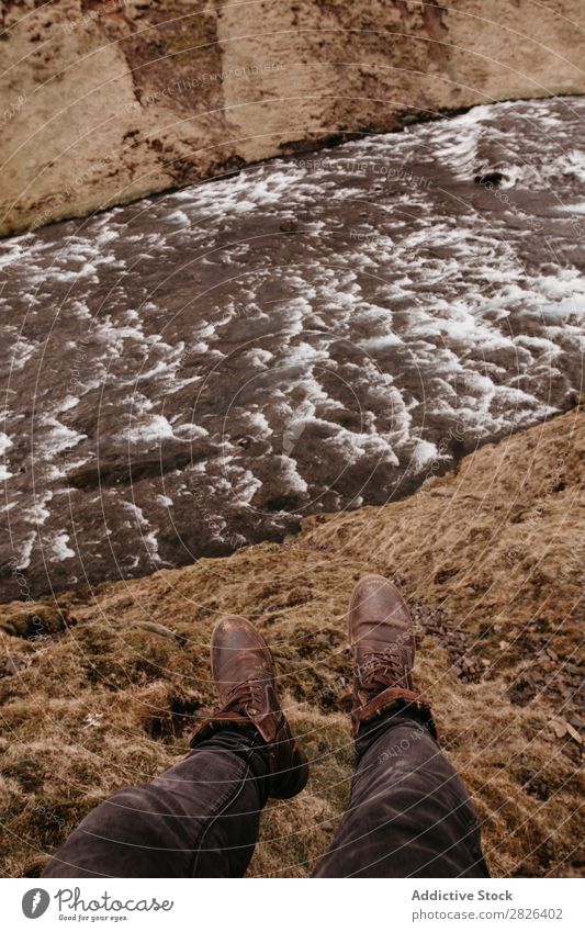 Man on rock with river flowing below Height River Landscape Extreme Iceland Rock Vantage point scenery Mountain Adventure Tourist Top Nature Wilderness