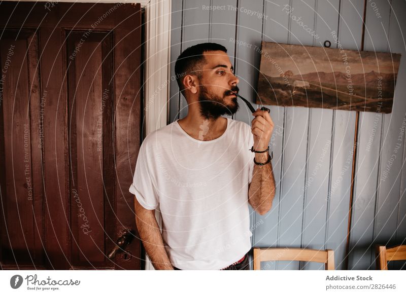 Man smoking pipe inside Pipe Hipster Style Adults House (Residential Structure) Iceland Tobacco Vintage Smoking bearded Posture Addiction Smoke Elegant