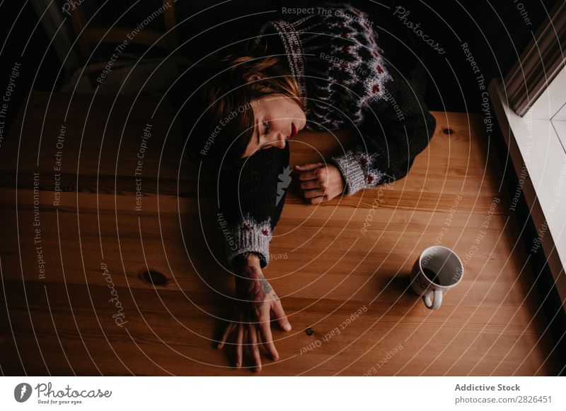 Woman lying on table with mug Table Sleep Iceland Home Morning exhausted Fatigue Dream asleep Stress Relaxation Interior shot Resting Mug Cup Refreshment