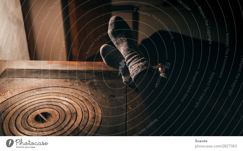 Woman leaning feet on warm oven Lifestyle Winter Winter vacation Mountain Fireside Human being Adults Legs Feet 1 To enjoy Warmth Joy Warm-heartedness