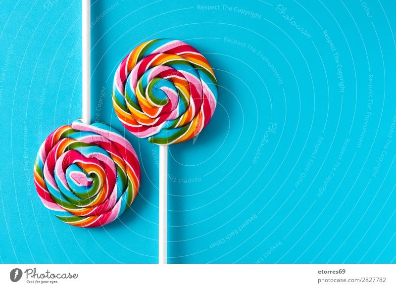 Colorful lollipops on blue background. Copyspace Lollipop Colour Multicoloured Sugar Candy Sweet Tasty Copy Space Food Healthy Eating Food photograph Dessert