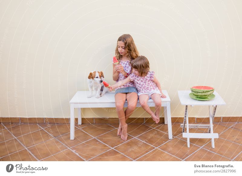 Two beautiful sister kids eating watermelon ice cream Fruit Ice cream Eating Joy Happy Vacation & Travel Summer House (Residential Structure) Garden Child