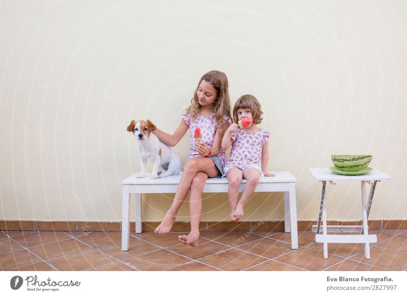 Two beautiful sister kids eating watermelon ice cream Fruit Ice cream Eating Joy Happy Vacation & Travel Summer House (Residential Structure) Garden Child