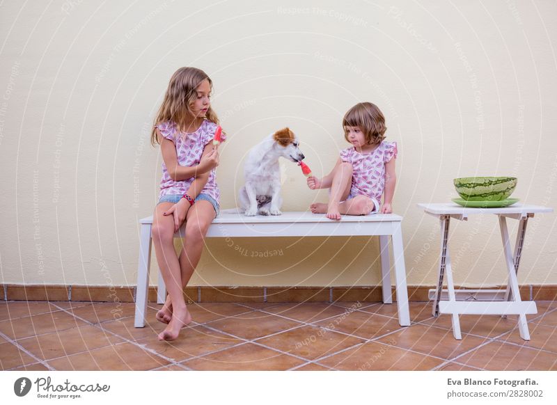 Two beautiful sister kids eating watermelon ice cream Fruit Ice cream Eating Joy Happy Vacation & Travel Summer House (Residential Structure) Garden Child