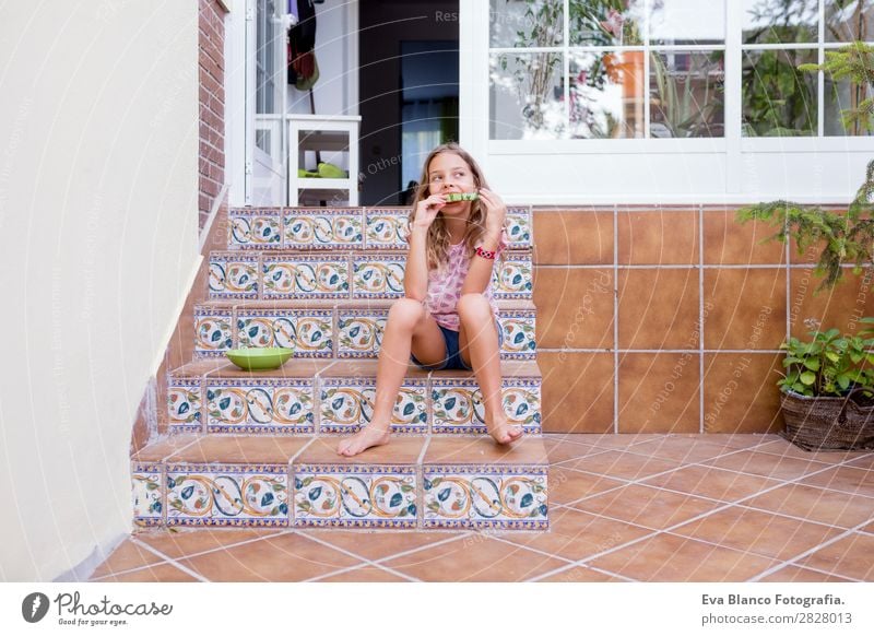 Beautiful kid girl eating watermelon at home Fruit Ice cream Eating Joy Happy Vacation & Travel Summer House (Residential Structure) Garden Child Friendship