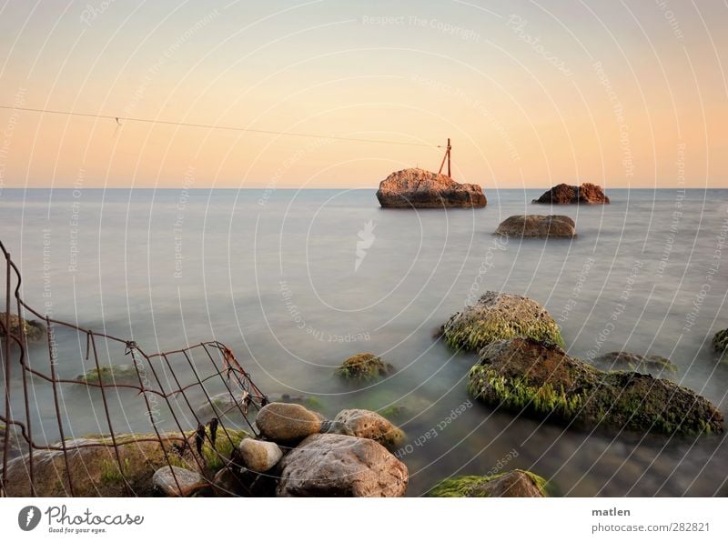 sea border Cable Landscape Sky Cloudless sky Horizon Sun Sunrise Sunset Summer Weather Beautiful weather Coast Beach Ocean Blue Green Orange Border Fence Rust