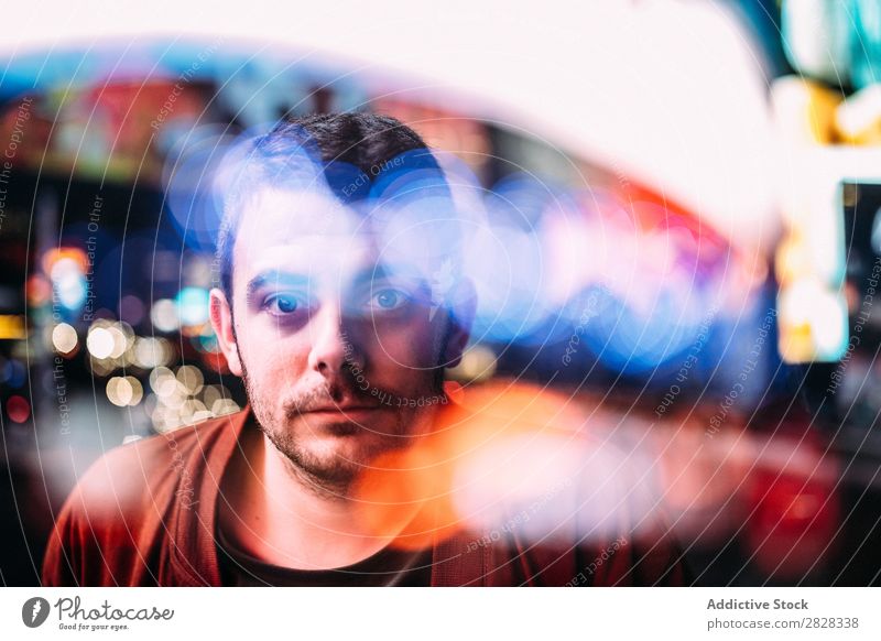 Man looking at camera through glass Looking into the camera Town Glass Reflection Adults Skyline Blur Multicoloured Youth (Young adults) Night Modern Action