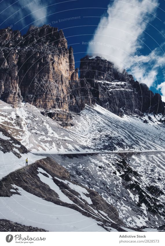 Man walking in snowy mountains Snow Mountain Tourist Vacation & Travel Winter Hiking Adventure Landscape Nature trekking Extreme hiker Mountaineering